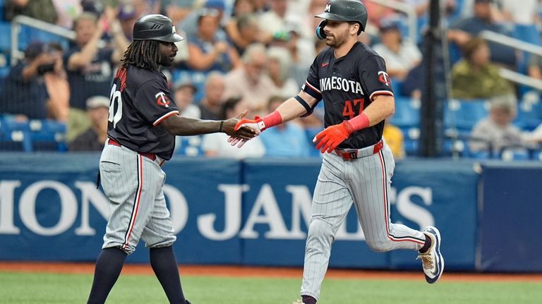 Minnesota Twins' Edouard Julien (47) celebrates his three-run home run...