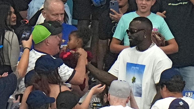 Former Tampa Bay Rays outfielder Randy Arozarena, right, shakes hands...