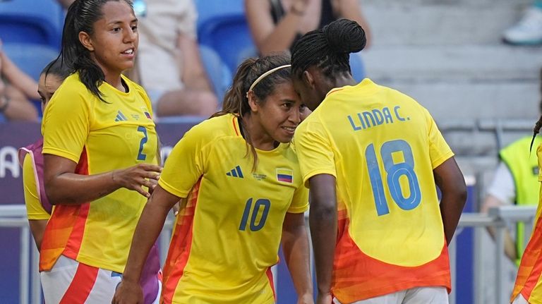 Colombia's Leicy Santos, center, celebrates with teammate Linda Caicedo after...