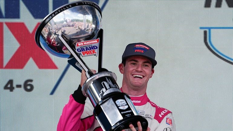 Kyle Kirkwood holds the trophy winning the Music City Grand...