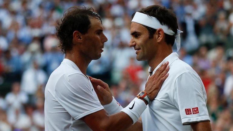 Roger Federer (right) and Rafael Nadal embrace at the net...