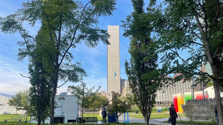 The U.N. Secretariat Building is seen through trees in a...