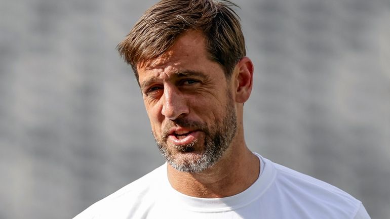 Jets quarterback Aaron Rodgers practices before an NFL preseason game against...