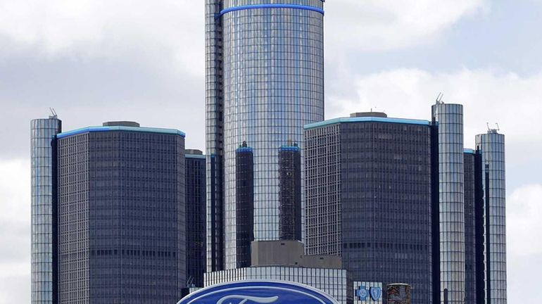 Ford signage is displayed outside of a dealership as the...