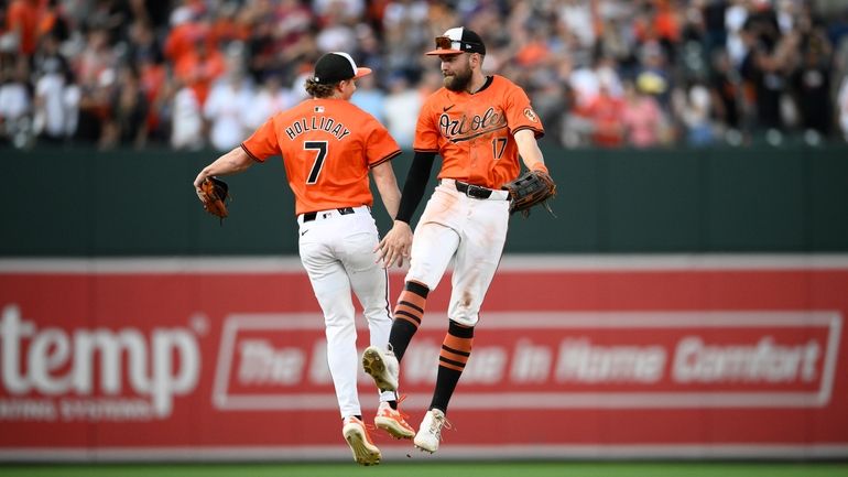 Baltimore Orioles' Jackson Holliday (7) and Colton Cowser (17) celebrate...