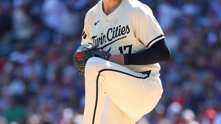 Minnesota Twins starting pitcher Bailey Ober winds up to deliver...