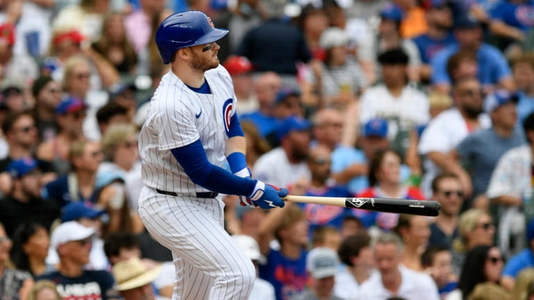 Chicago Cubs' Ian Happ watches his three-run home run during...