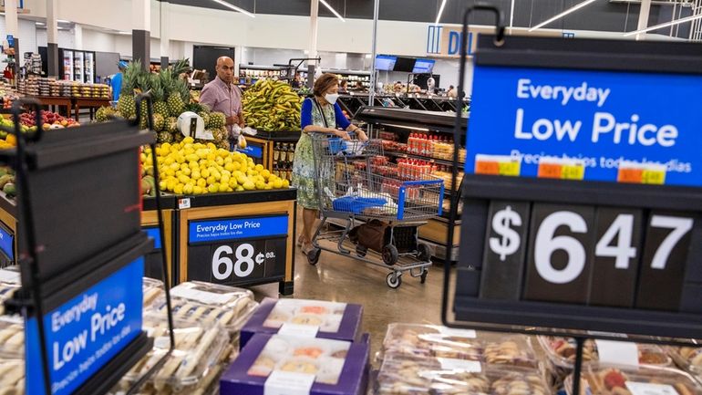 People buy groceries at a Walmart Superstore in Secaucus, New...