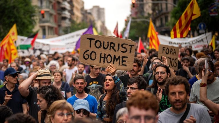 Demonstrators march shouting slogans against the Formula 1 Barcelona Fan...