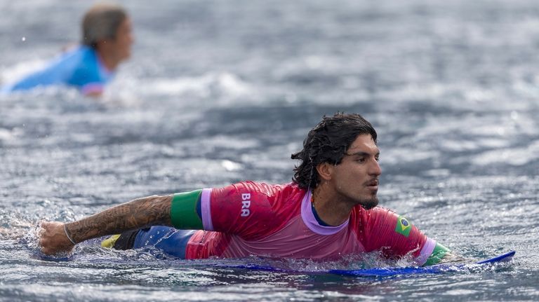 Brazil's Gabriel Medina paddles in the men's surfing third round...