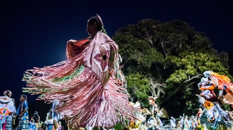 Tribe members dance in the Grand Entry at the 69th...