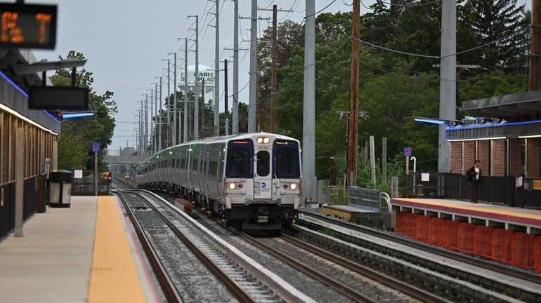 A train carries Gov. Kathy Hochul and rail officials celebrating the completion of...