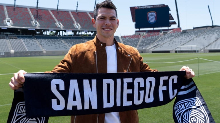 Hirving "Chucky" Lozano poses with a San Diego FC scarf...