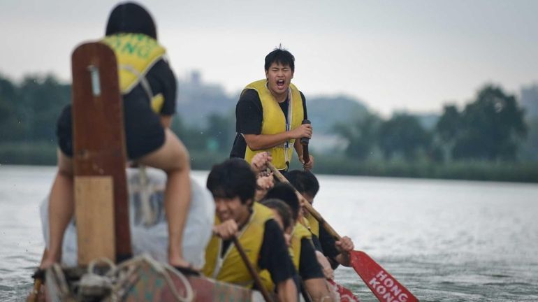 Alan Chan, 20, of Queens, encourages his fellow teammates of...