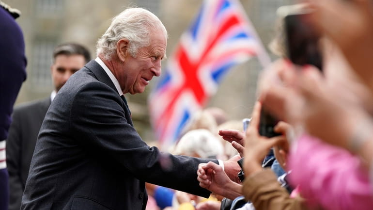 Britain's King Charles III meets members of the public during...
