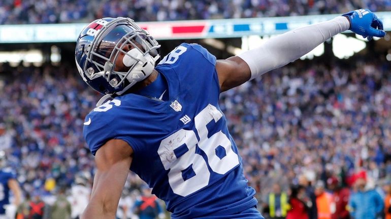 Darius Slayton of the Giants celebrates his third-quarter touchdown against the Texans...