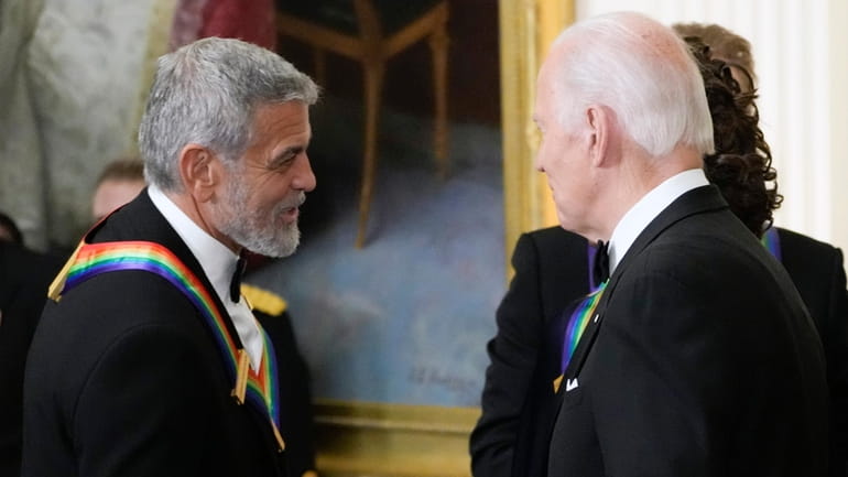 President Joe Biden shakes hands with actor, director and producer...