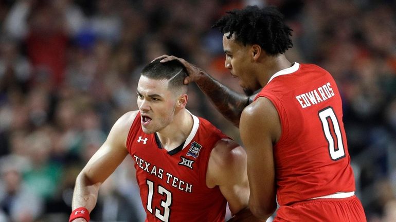 Texas Tech's Matt Mooney (13) celebrates with teammate Kyler Edwards...