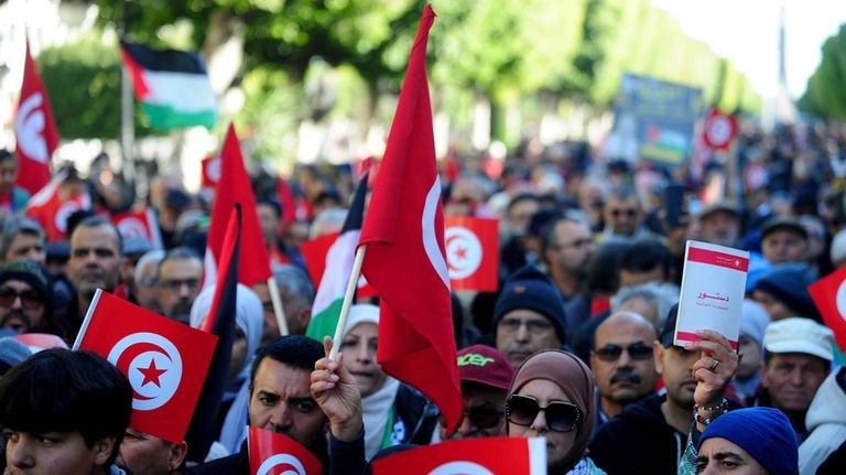 People commemorate the 13th anniversary of the Tunisian uprising in...