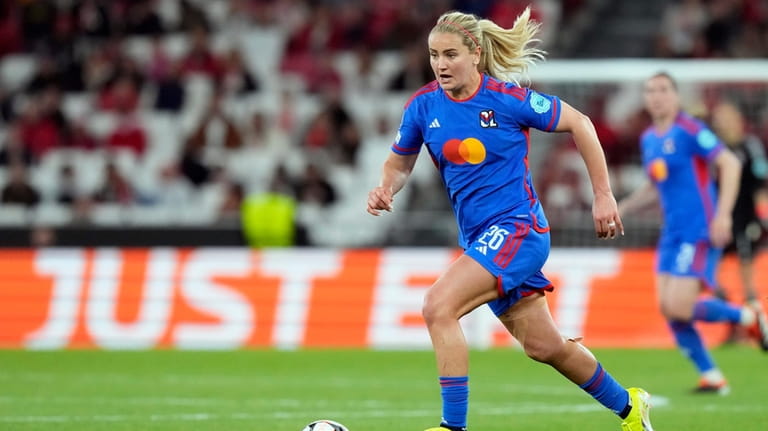 Lyon's Lindsey Horan runs with the ball during the women's...