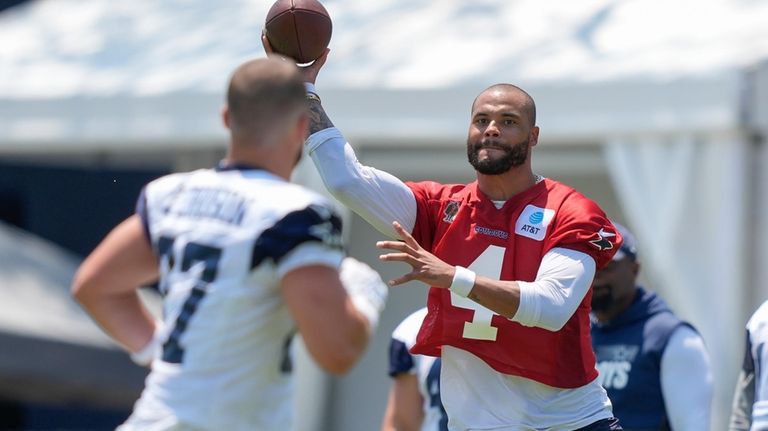 Dallas Cowboys quarterback Dak Prescott throws a pass to tight...