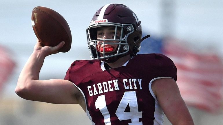 Luke Schmitt #14, Garden City quarterback, completes a pass during...