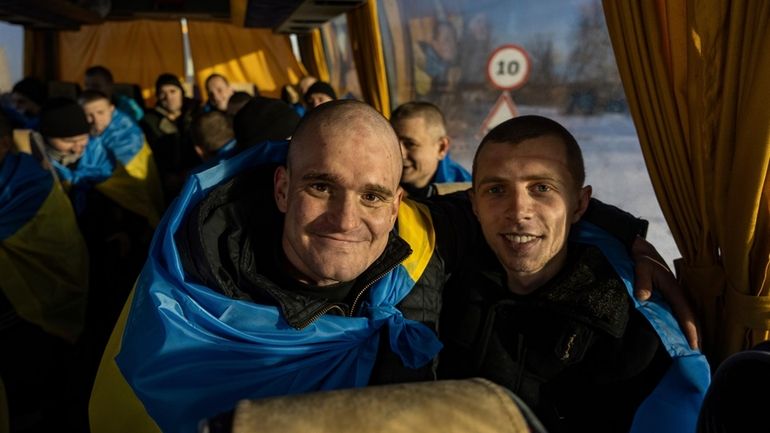 Recently swapped Ukrainian prisoners of war covered in national flags...