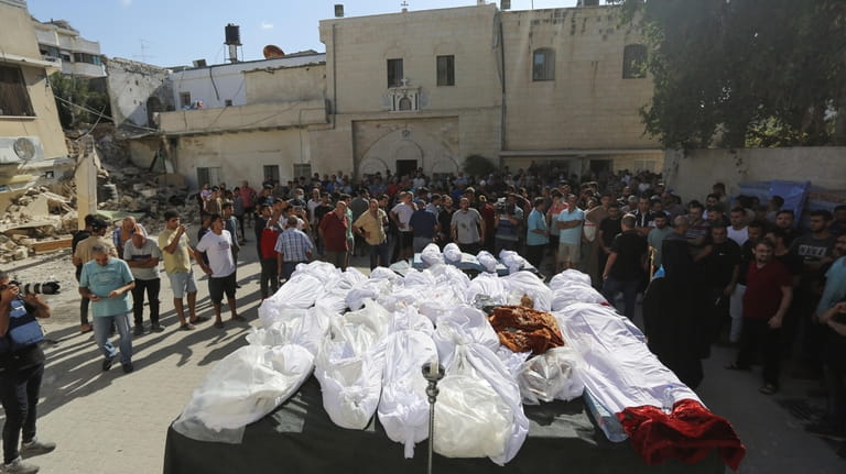 Relatives attend the funeral of Palestinians who were killed in...