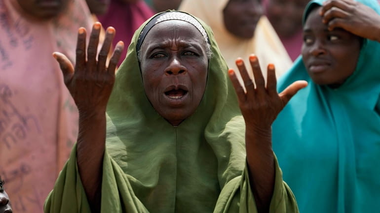 A women prays for the kidnapped LEA Primary and Secondary...