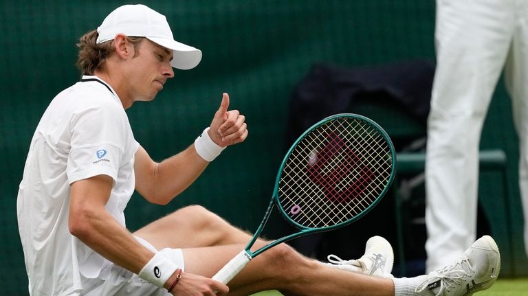 Alex de Minaur of Australia gestures after a fall during...