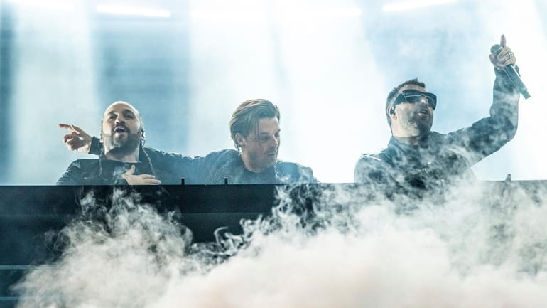 Swedish House Mafia, featuring Steve Angello, from left, Axwell, and...