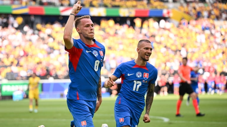 Slovakia's Ondrej Duda, left, celebrates scoring the opening goal against...