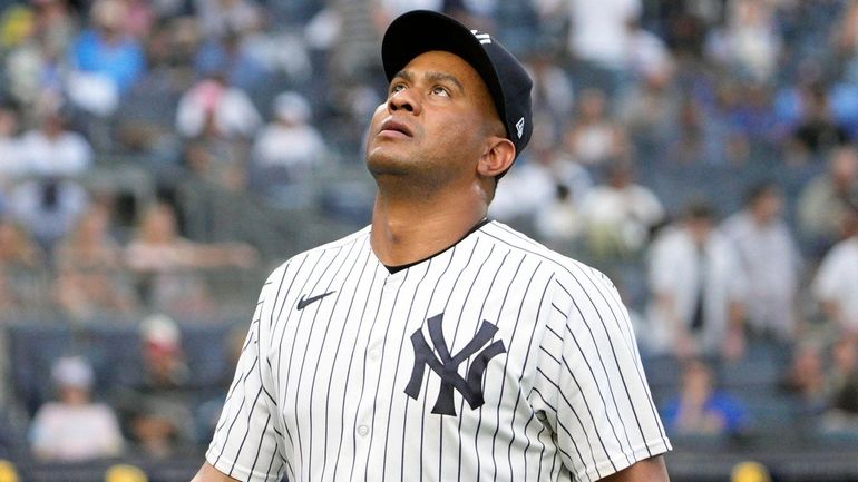 Yankees pitcher Wandy Peralta walks off the mound in the middle...