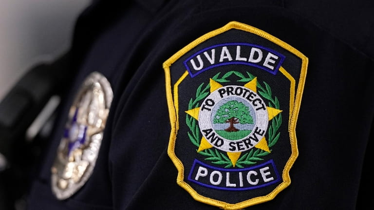 A Uvalde police officers patch and badge is seen as...