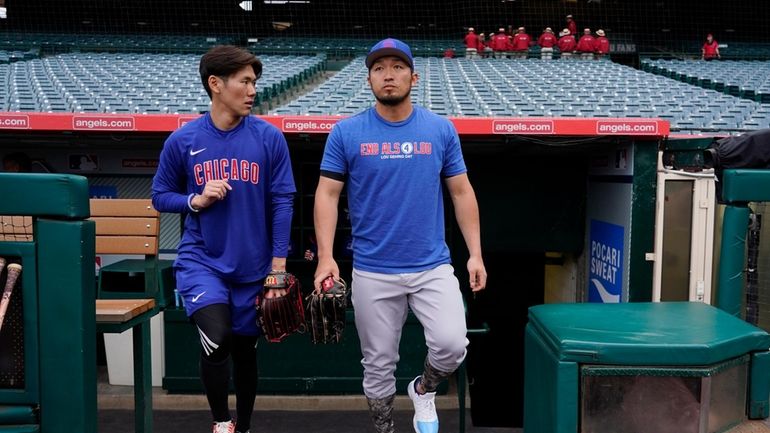 Chicago Cubs' Seiya Suzuki, right, and his interpreter, Toy Matsushita,...