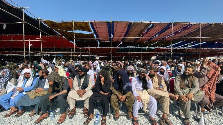 Afghans attend a ceremony to celebrate the third anniversary of...