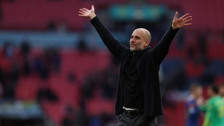 Manchester City's head coach Pep Guardiola celebrates on full time...