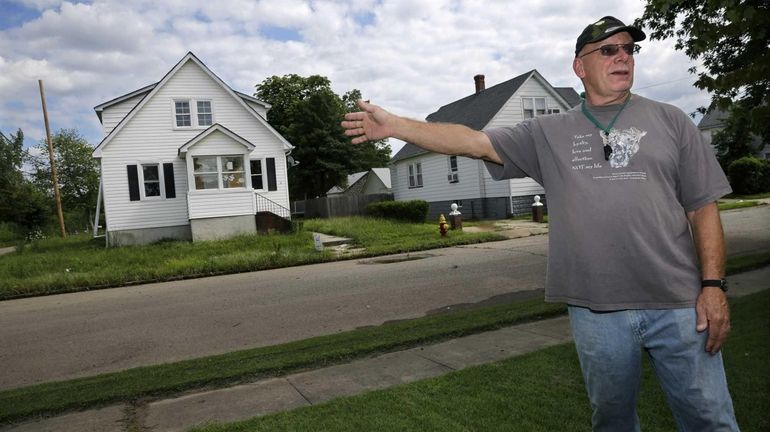 Tom Deltz stands in front of his Lee Street home...