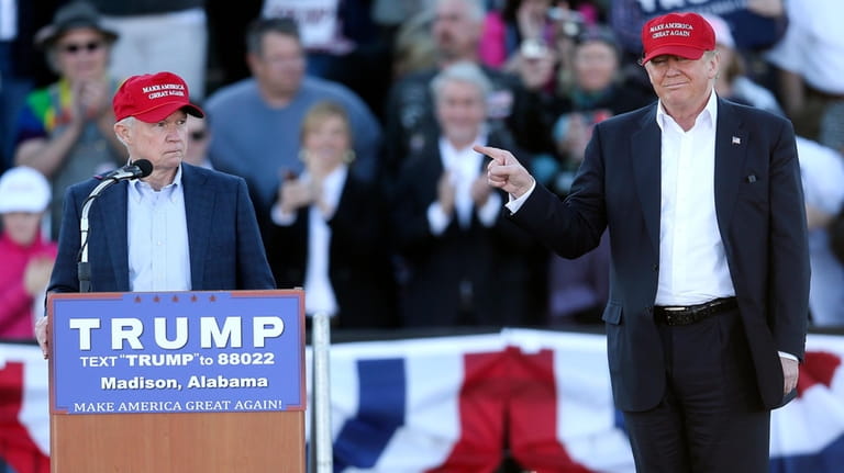 Republican presidential candidate Donald Trump, right, gestures as Sen. Jeff...