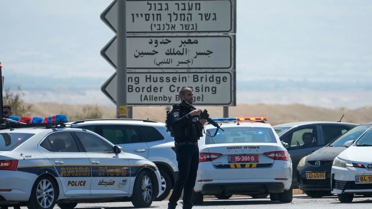 Israeli police stand guard near the site of a deadly...