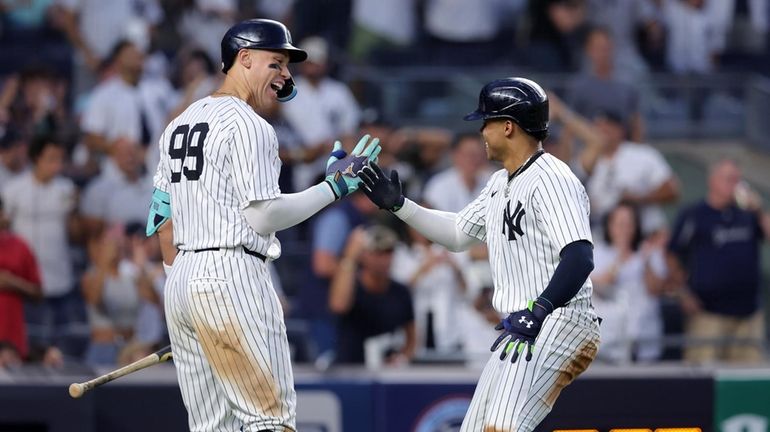 Yankees rightfielder Juan Soto celebrates with designated hitter Aaron Judge...