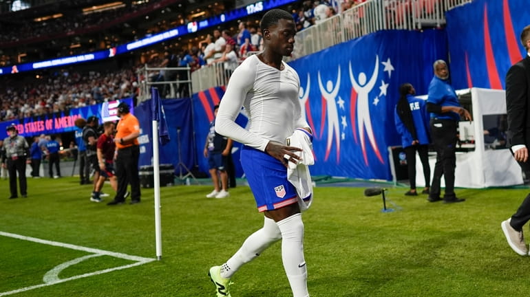 Tim Weah of the United States leaves the field after...