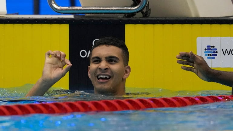 Palestinian swimmer Yazan Al Bawwab reacts during the men's 100m...
