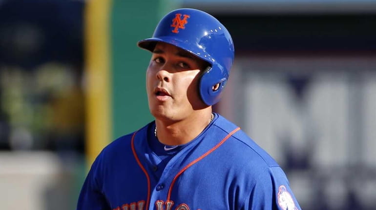 The New York Mets' Ruben Tejada rounds second after hitting...