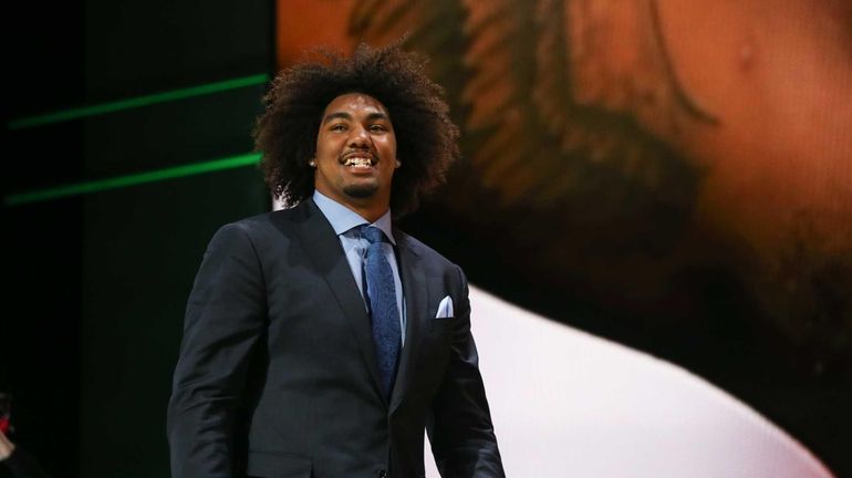 Leonard Williams of the USC Trojans walks on stage after...