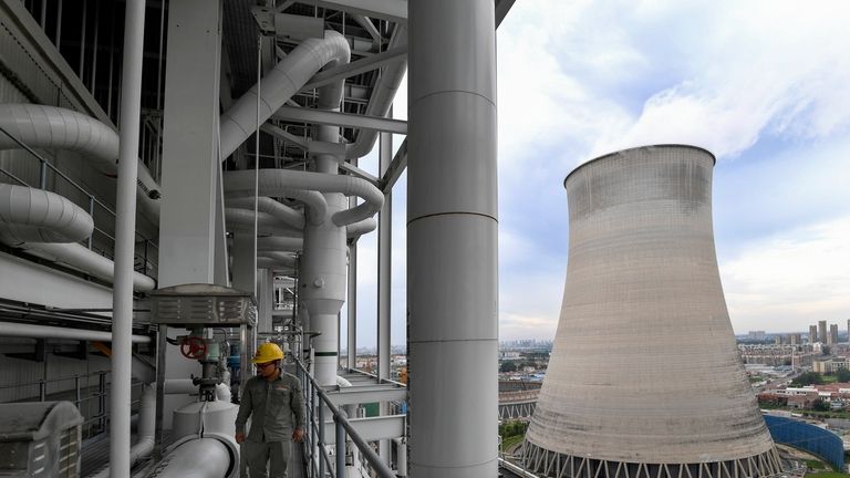 A worker inspects facilities at a coal-fired power plant in...