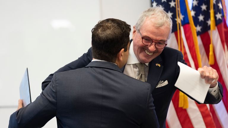 New Jersey Gov. Phil Murphy, right, greets George Helmy after...