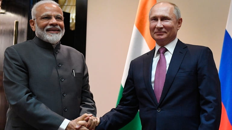 FILE- Russian President Vladimir Putin, right, and Indian Prime Minister...