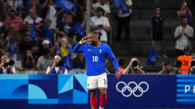 France's Alexandre Lacazette celebrates after scoring his side's first goal...