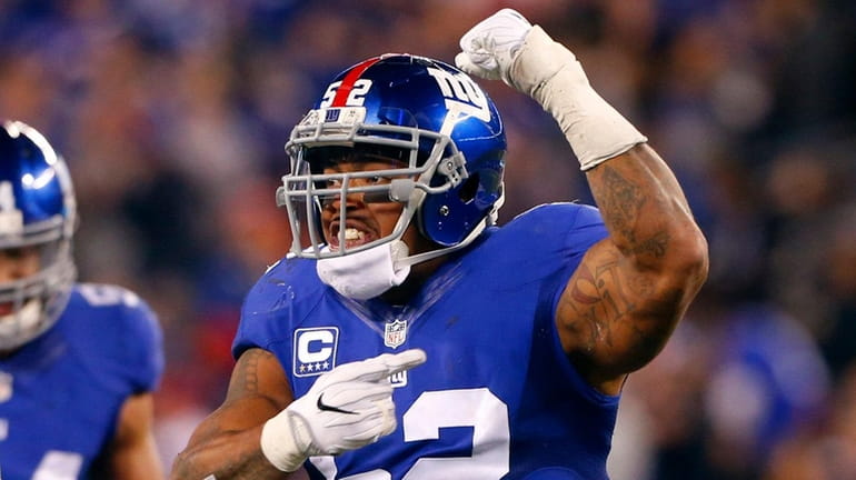 Jonathan Casillas #52 of the New York Giants reacts after...
